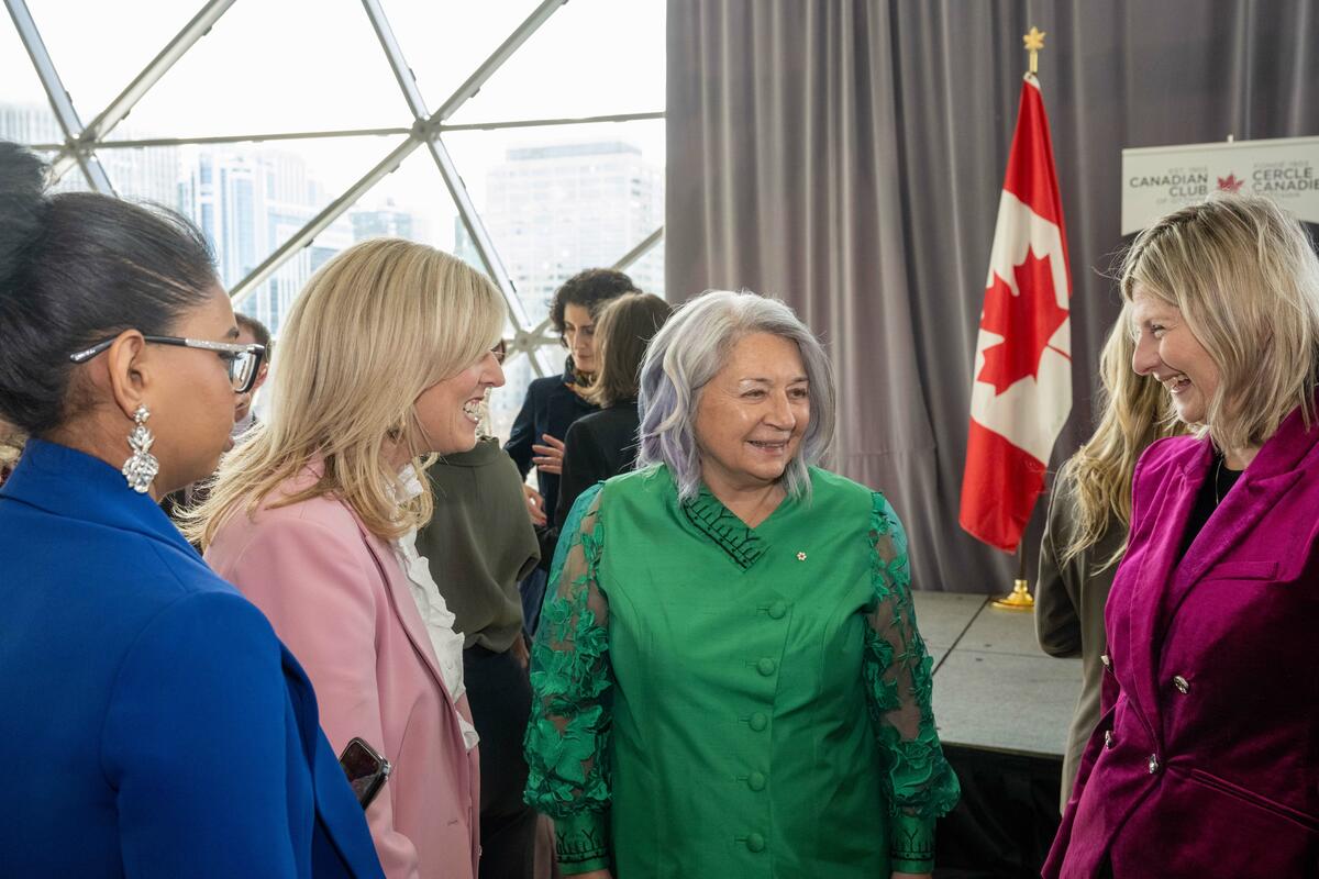Governor General Mary Simon speaks with three women who attended the event