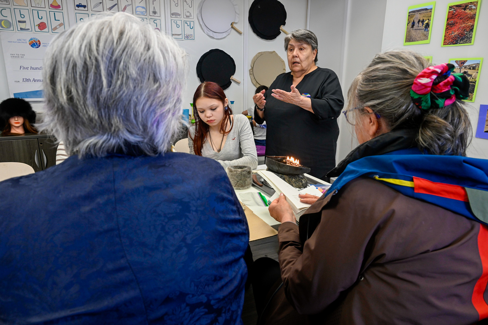 Governor General Mary Simon having a discussion with a group of individuals at the Piruqatigiit Resource Centre.