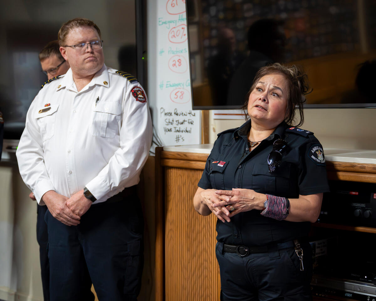 Two first responders speaking in a room.