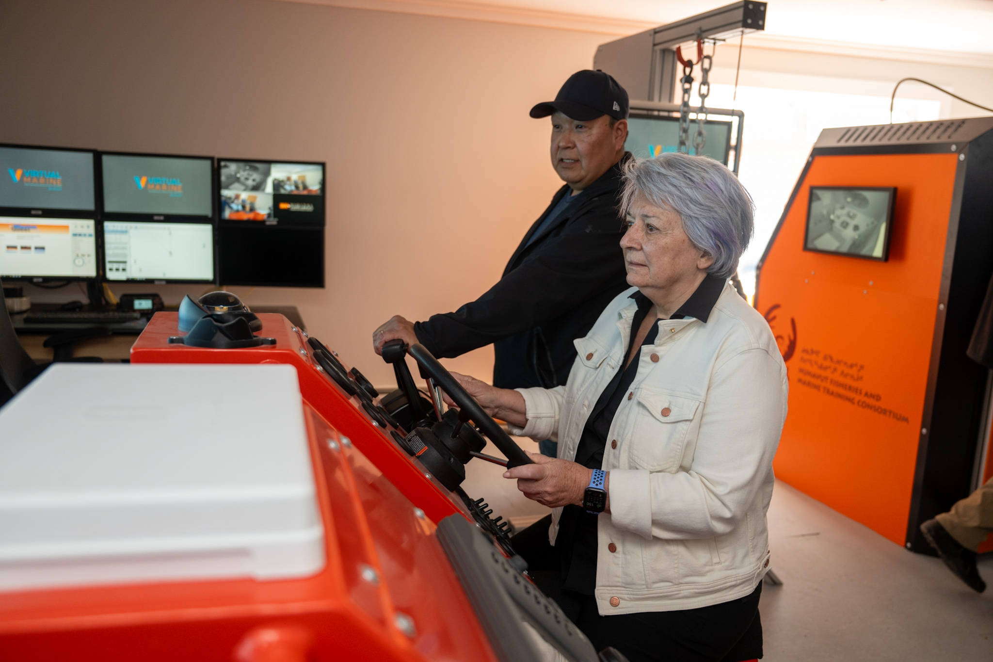 Governor General Mary Simon at the Nunavut Fisheries and Marine Training Consortium trying the simulated electronic navigation.
