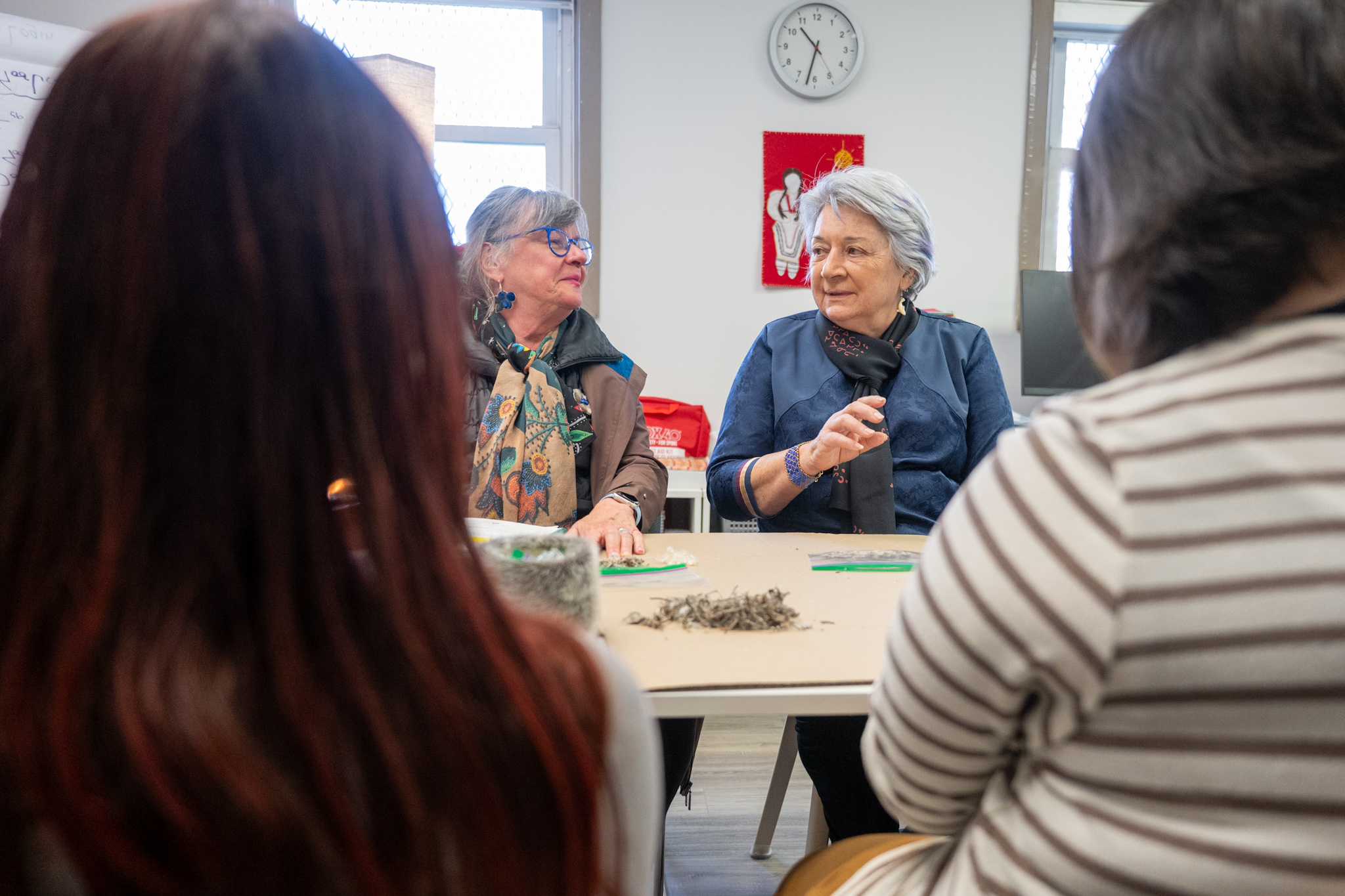 Governor General Mary Simon having a discussion with a group of individuals at the Piruqatigiit Resource Centre.