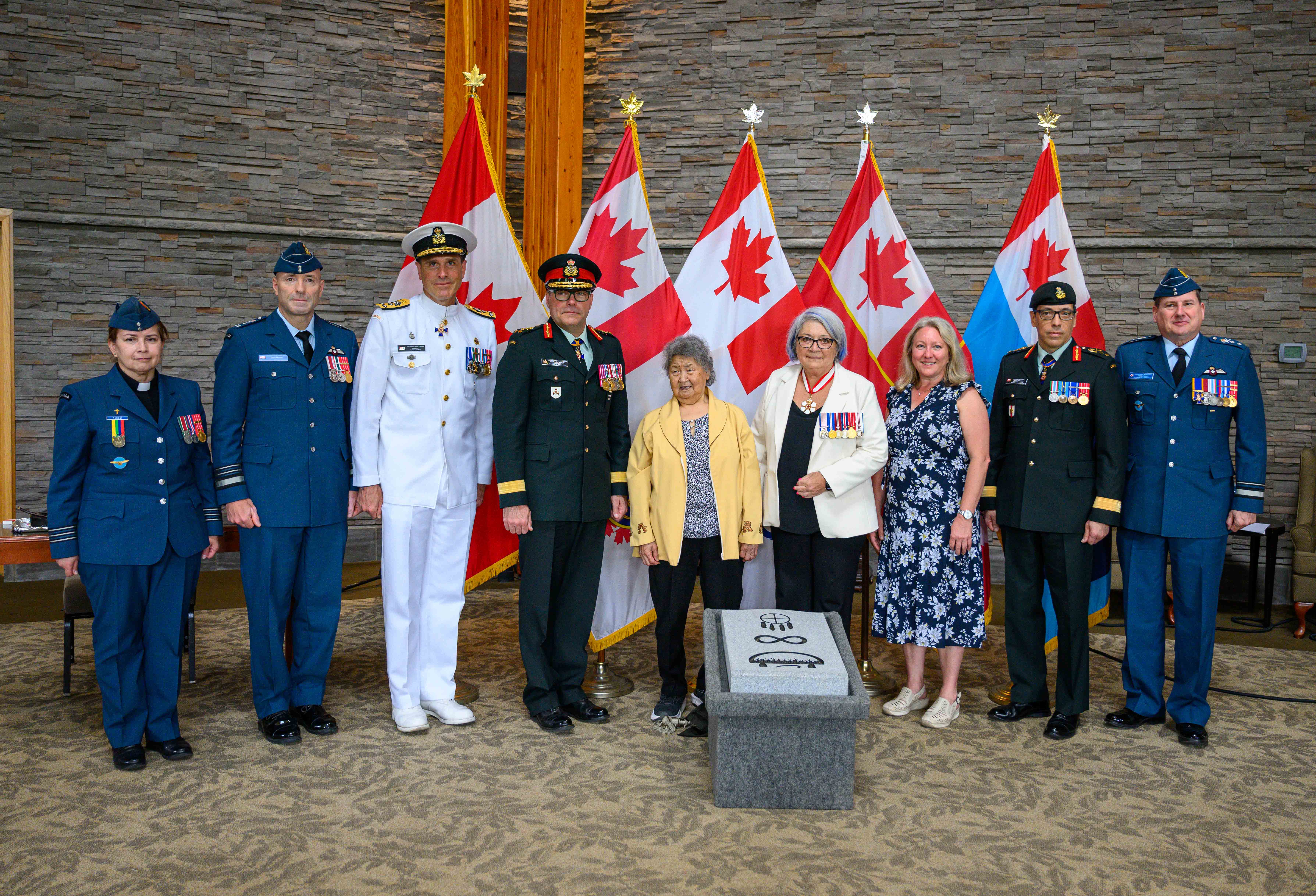 Governor General Mary Simon standing with military members at unveiling of the third Indigenous spiritual symbol, the qulliq, as an approved optional spiritual emblem for engraving on headstones at the National Military Cemeterydee