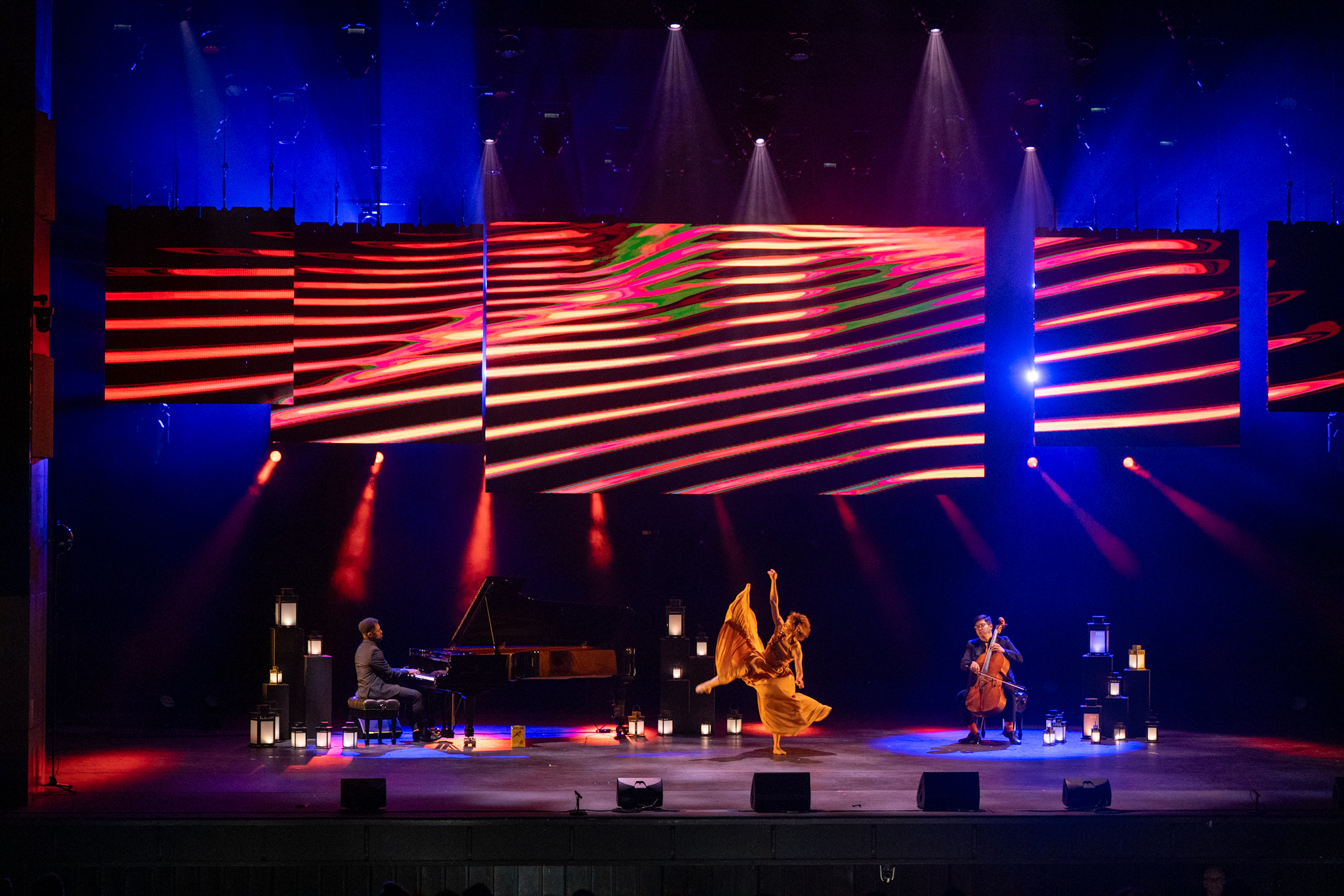 Un pianiste, un violoncelliste et une danseuse se produisent sur scène au Centre National des Arts dans le cadre de la cérémonie des Prix du Gouverneur général pour les arts du spectacle. Plusieurs lanternes sont disposées sur la scène. 