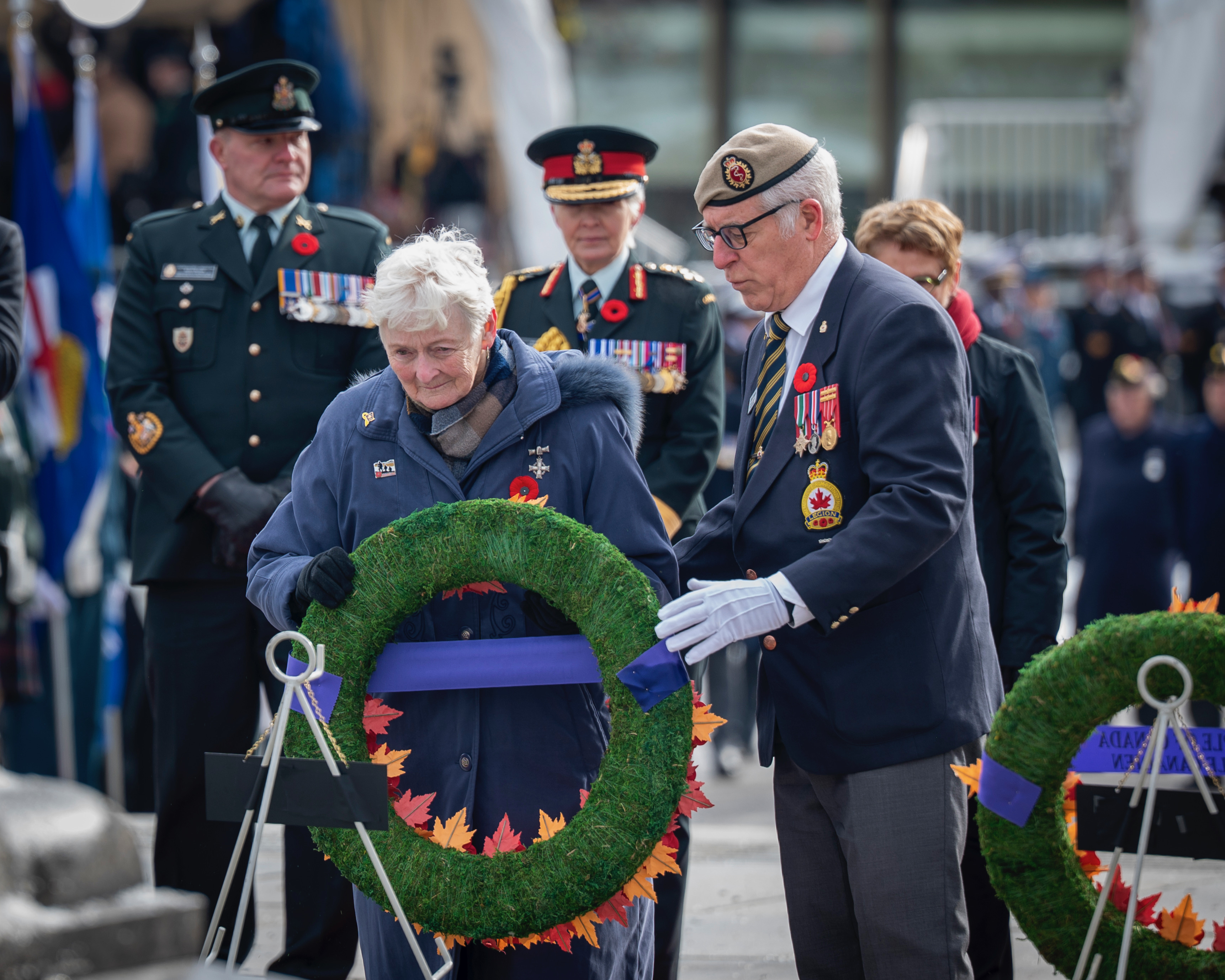 A woman placing a wreath at the War Memorial in Ottawa.