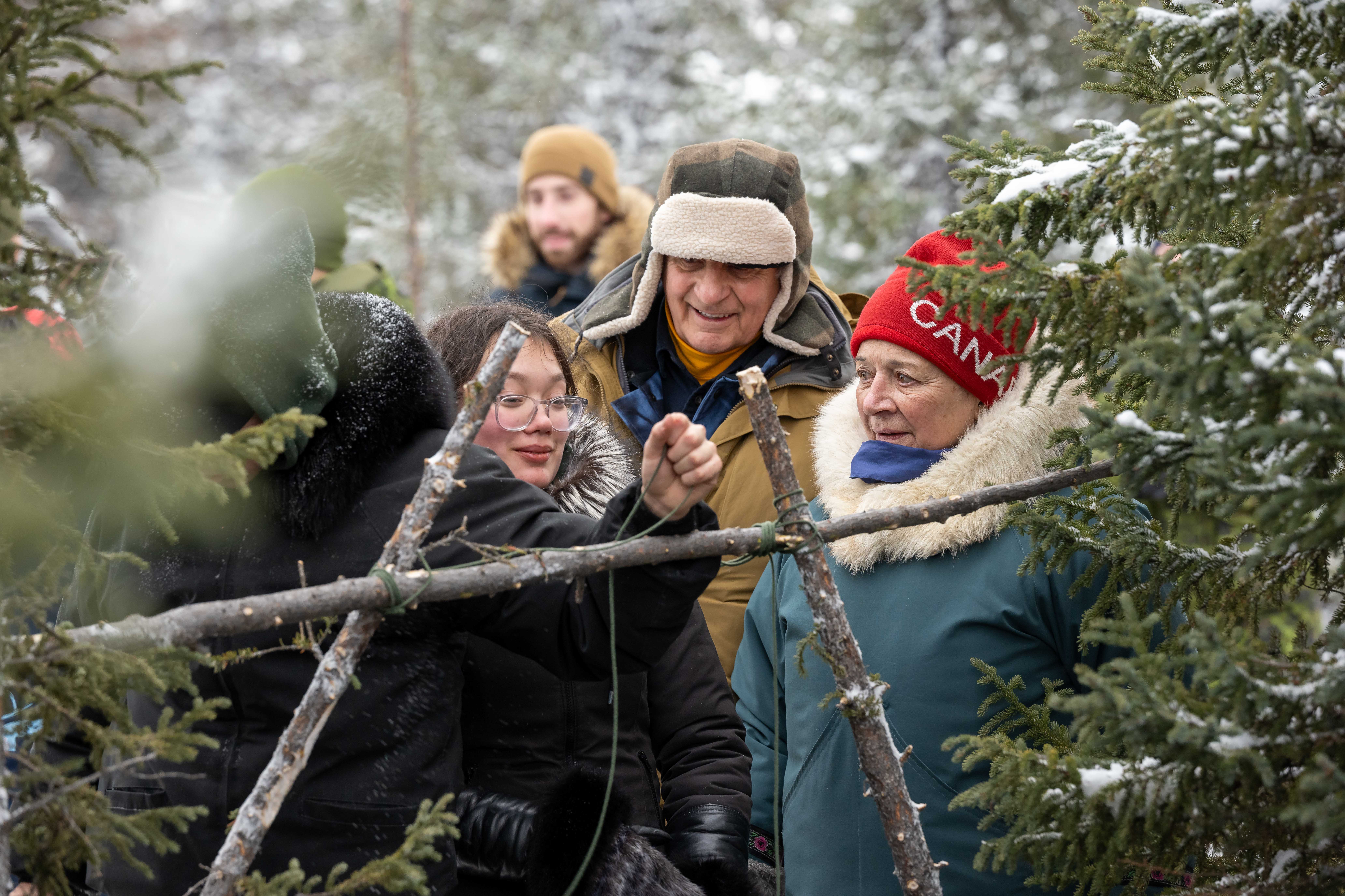 Governor General Mary Simon watches Junior Rangers build shelters