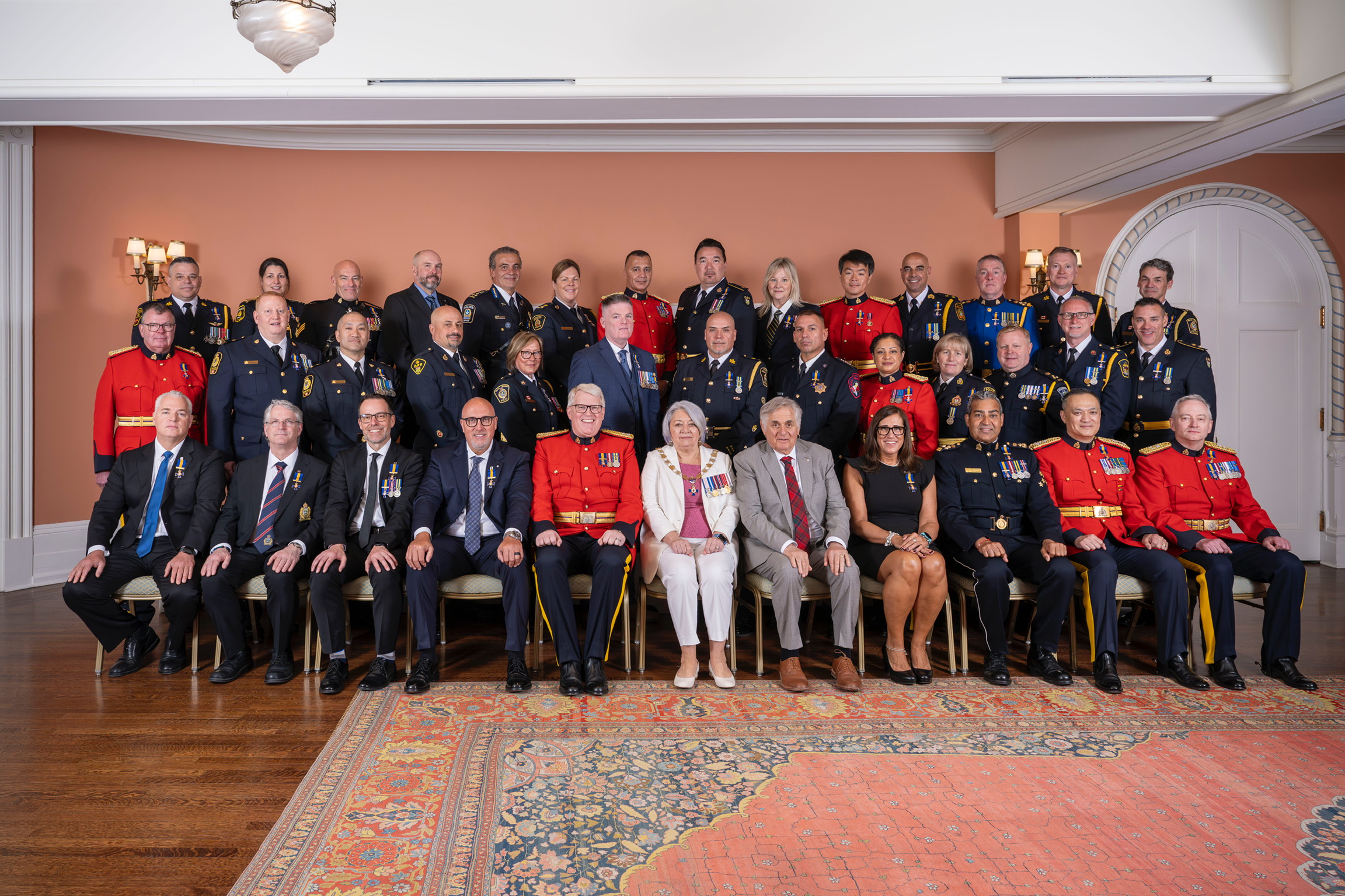 Governor General Mary Simon and Mr. Whit Fraser with recipients of the Order of Merit of the Police Forces.