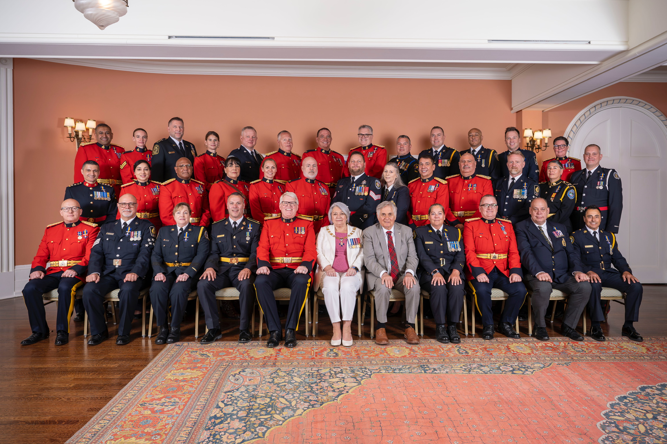 Governor General Mary Simon and Mr. Whit Fraser with recipients of the Order of Merit of the Police Forces.
