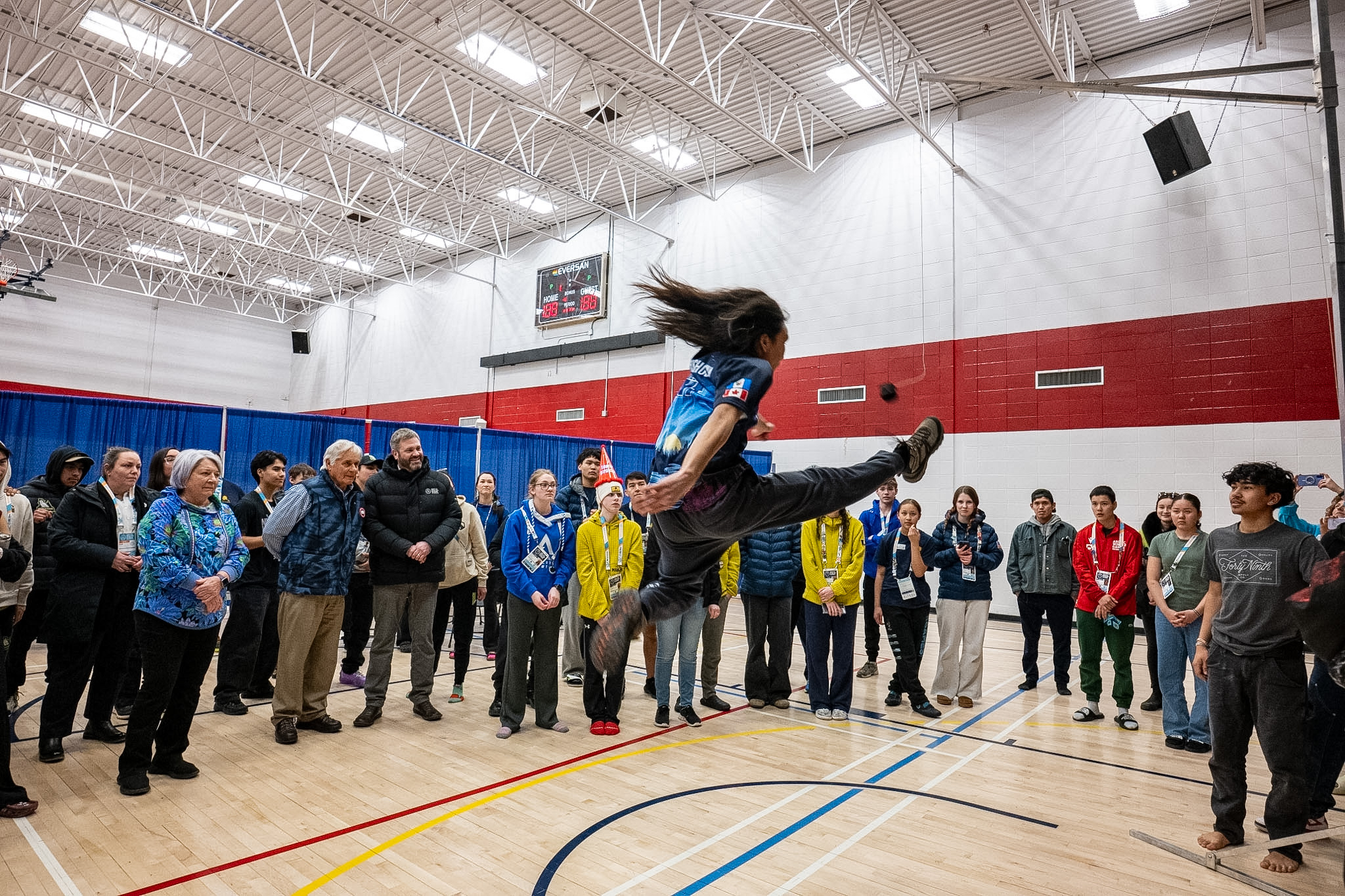 An individual doing a high kick at the Arctic Winter Games.