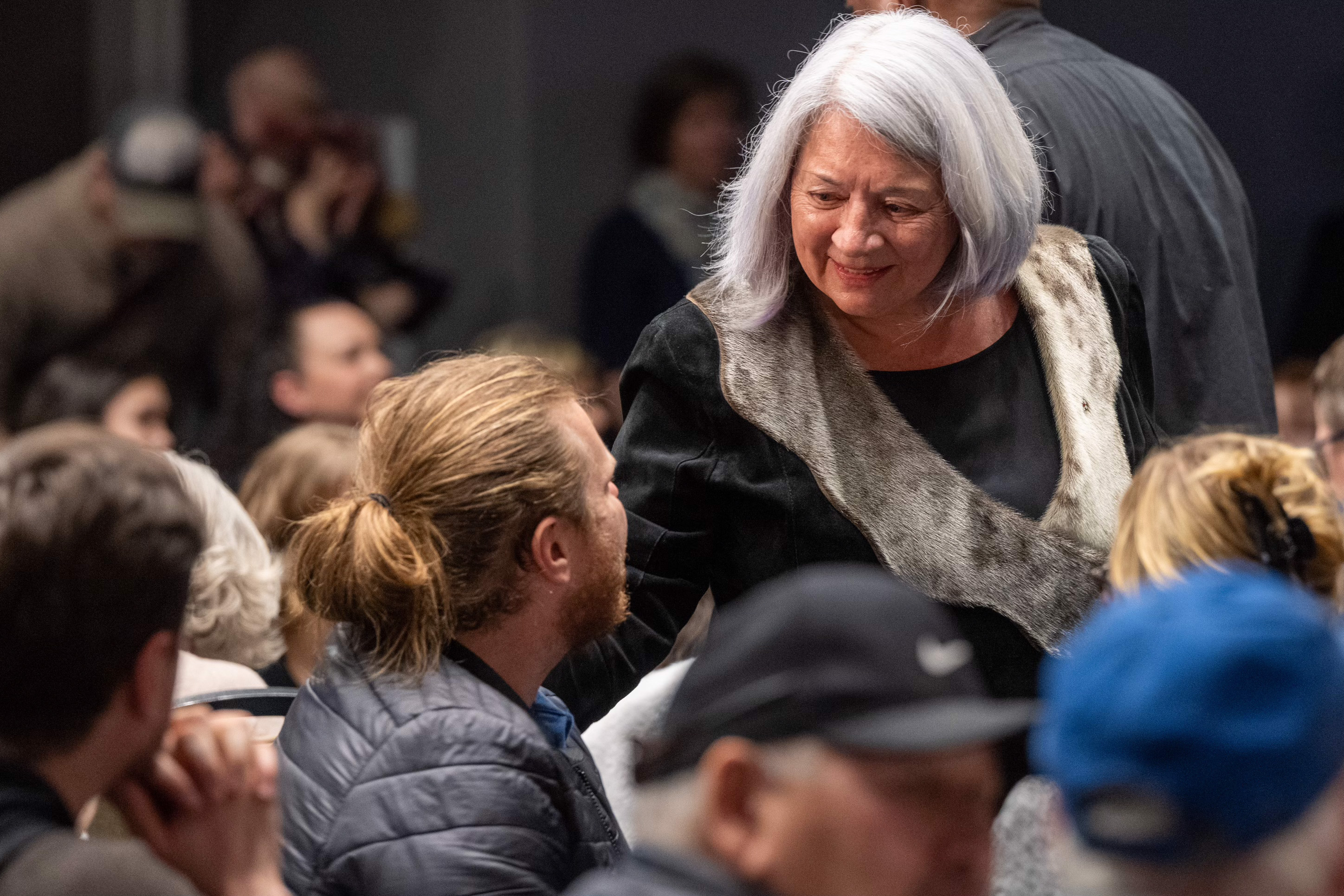 Governor General Mary Simon speaks with a man in the crowd