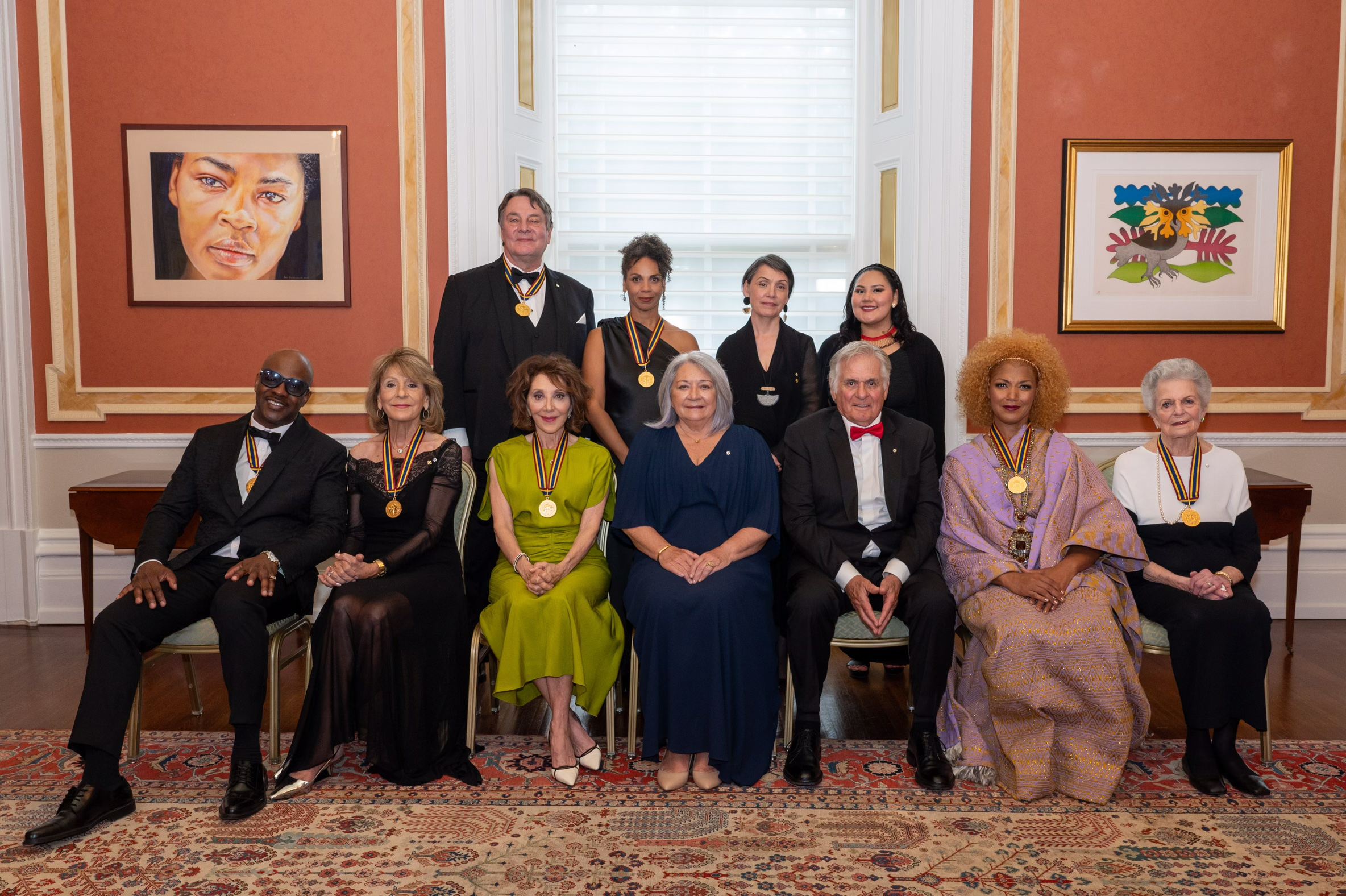 Governor General Mary Simon sits with the laureats for a group photo in the Large Drawing Room at Rideau Hall.