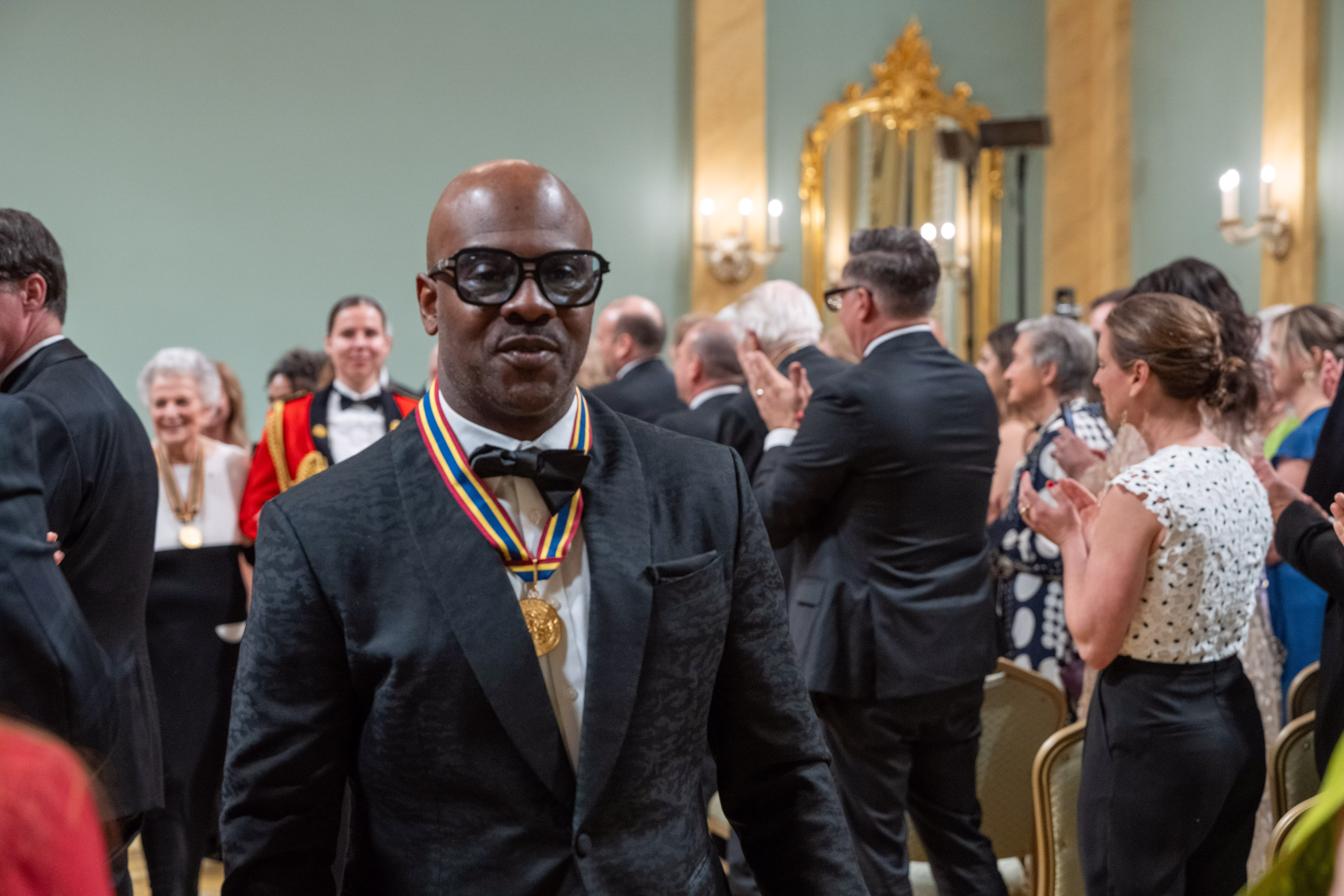 Wes “Maestro” Williams walks out of the Ballroom at Rideau Hall through the audience