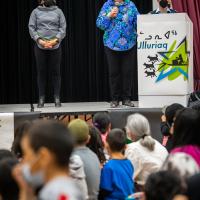 The Governor General is speaking at a podium in a school.