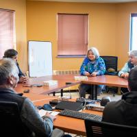 The Governor General is seated in a conference room.