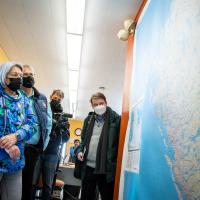 Their Excellencies are looking at a large map.