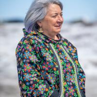 The Governor General is wearing a beautifully decorated hooded shirt.