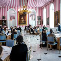 A group of women at round tables in the Tent Room at Rideau Hall.