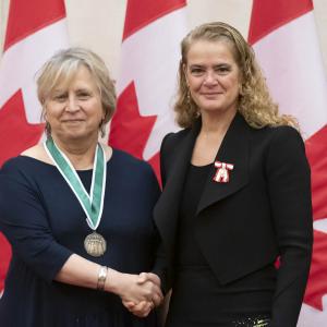 Rina Fraticelli is posing for a picture with the Governor General.