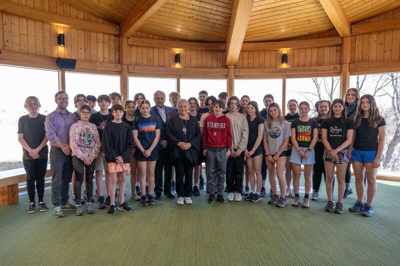 Governor General Simon and Mr. Whit  Fraser standing with a group of youth.