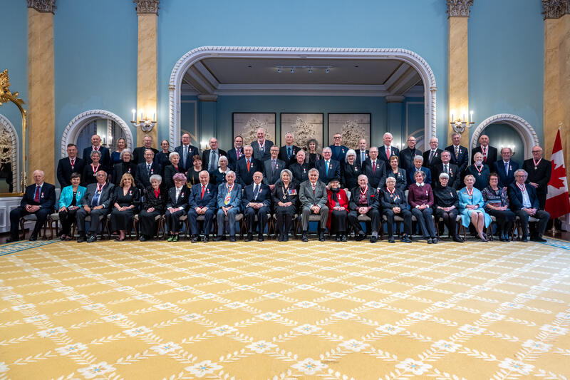 Governor General Mary Simon sits with the recipients