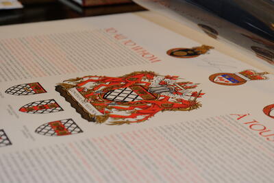 Piece of paper with a Coat of Arms and writing on it.