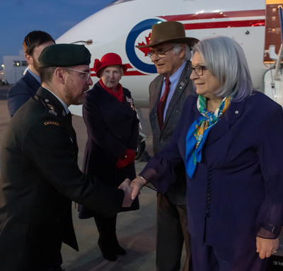 Governor General Mary Simon is shaking hands with a member of the military.