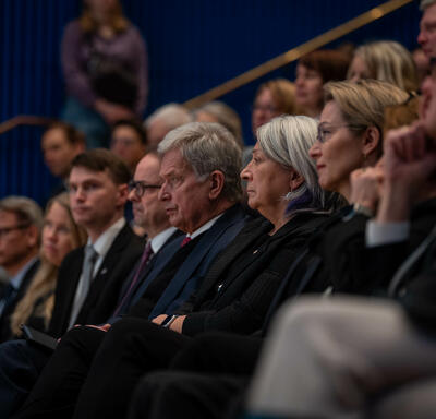 Governor General Simon sitting in an audience. Sauli Niinistö, President of the Republic of Finland, is seated next to her.