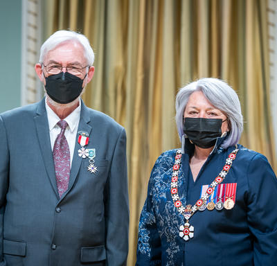 Imant Karlis Raminsh is standing next to the Governor General.