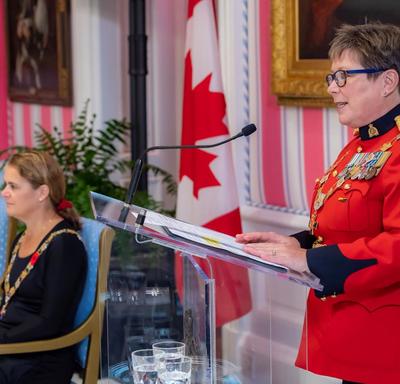 Brenda Lucki, Commissioner of the RCMP, delivers remarks at a podium during an Order of Merit of the Police Forces investiture ceremony.