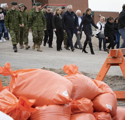 La gouverneure générale marche aux côtés d'un groupe de membres des Forces armées canadiennes. 