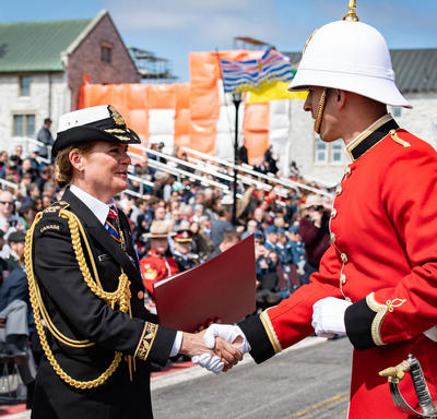 The Governor General hands commissioning scrolls to a member of RMC.