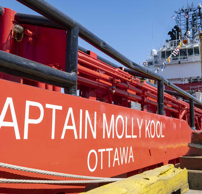 Side view of the red and white Canadian Coast Guard Ship Captain Molly Kool.