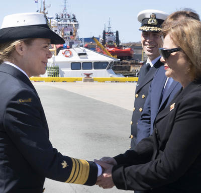 Governor General Julie Payette shakes hands outside, on a sunny day, at a port, with Her Honour the Honourable Judy May Foote, Lieutenant Governor of Newfoundland and Labrador.