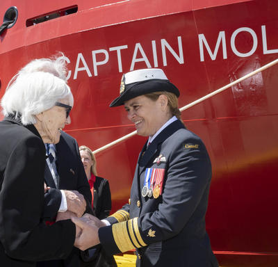 Ms. Martha Miller, 92 years old, is shaking hands with Governor General Julie Payette, in front of the Captain Molly Kool ship.