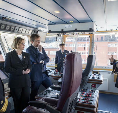 A group of 4 people including Governor General Julie Payette is listening to a Canadian Coast Guard official, inside the cockpit of the ship Captain Molly Kool.