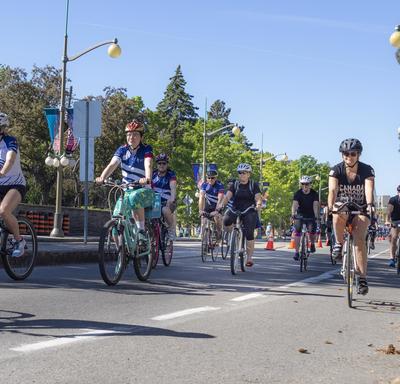 The Governor General cycles along Sussex Drive alongside Navy Bike Ride participants