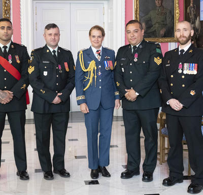 Petty Officer 1st Class Charles Bressette, Sergeant Andrea Karistinos and master corporals Kashif Dar and Jesus Castillo take a photo with the Governor General.