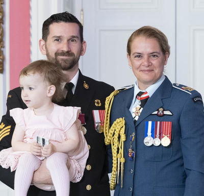 Petty Officer 2nd Class Matthew Compeau takes a photo with his daughter and the Governor General.