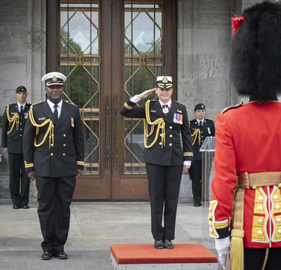 The Governor General, with the aide-de-camp by her side, salutes the Ceremonial Guard and the Commander.