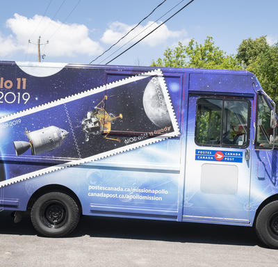 A photo of a Canada Post truck painted with the Apollo 11 design.