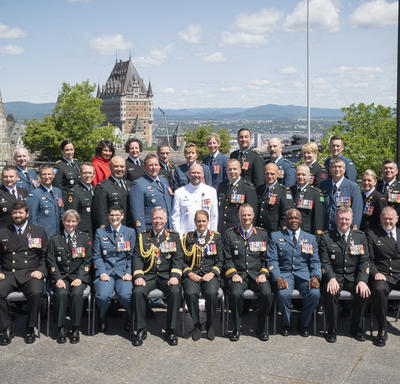 Newly invested members of the Order of Military Merit take a photo as a group. 