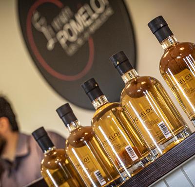 A photo of Verger Poméloi cider bottles lined up, sealed and ready for distribution.
