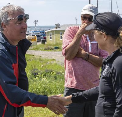 The Governor General meets and shakes hands with a local resident at Île d’Entrée.