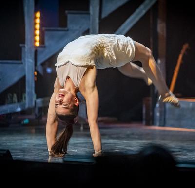 A woman performs acrobatics. 