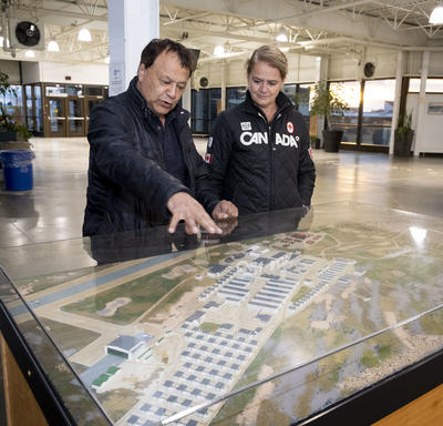 The Governor General and the mayor looking at a plan of Churchill. 
