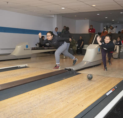 Members of the community bowling. 