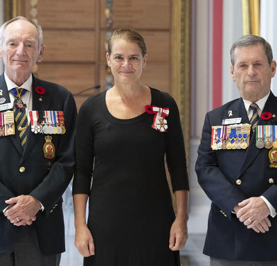 The Governor General stands for a photo alongside The Royal Canadian Legion executives, after receiving the symbolic first poppy.