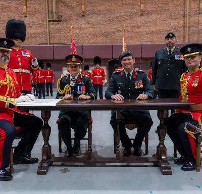 The Governor General takes part in the official signing of the Change of Command certificates.