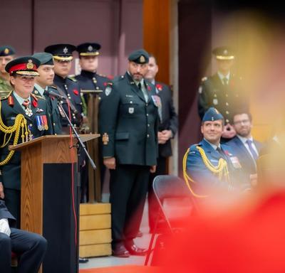 The Governor General delivers a speech at a podium during a Governor General's Foot Guards change of command ceremony. 