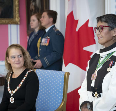 The Governor General looks on as a recipient is invested into the Order of Canada.