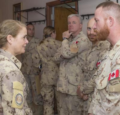 The Governor General talks to a group of troops. 